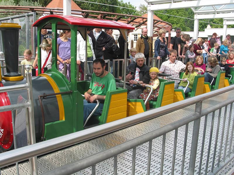 Junge Leute in einer Bahn im Themenpark